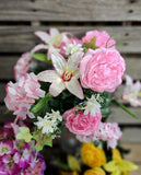 Mixed lily and rose bush